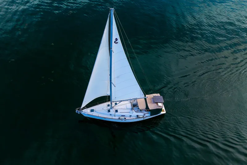 Eda Yacht Photos Pics Beneteau Oceanis 461 sailboat from 2000 gliding on calm waters, aerial view.