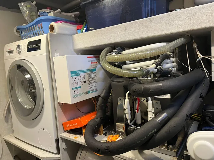  Yacht Photos Pics Laundry room with washing machine, plumbing, and storage on a NEEL 51, 2017 model.