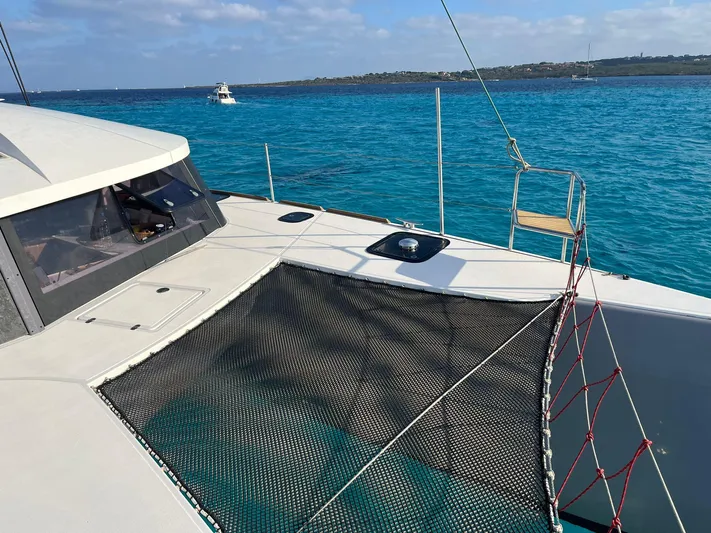  Yacht Photos Pics 2017 NEEL 51 trimaran on turquoise sea with clear sky and distant boats.