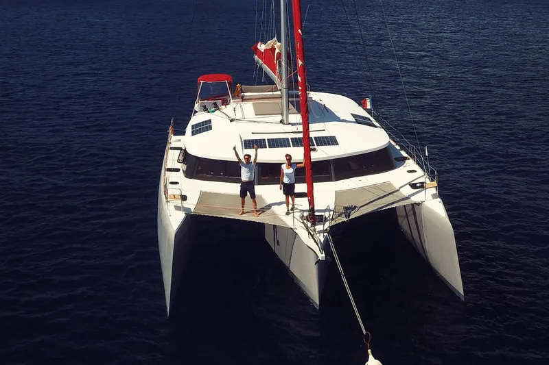  Yacht Photos Pics 2017 NEEL 51 trimaran sailing on open water with two people on deck.