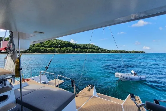  Yacht Photos Pics NEEL 51 trimaran on clear blue water near lush green island, 2017 model.