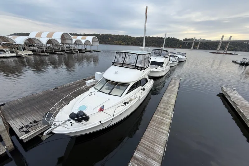 Baby Cake Yacht Photos Pics 2004 Meridian 381 Sedan yacht docked at marina with scenic bridge view.