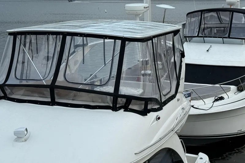 Baby Cake Yacht Photos Pics 2004 Meridian 381 Sedan boats docked with clear enclosures on a calm waterway.