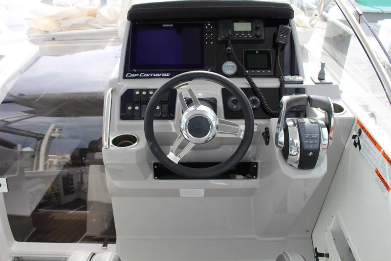  Yacht Photos Pics 2021 Jeanneau Leader 9.0 WA helm with steering wheel and navigation controls.
