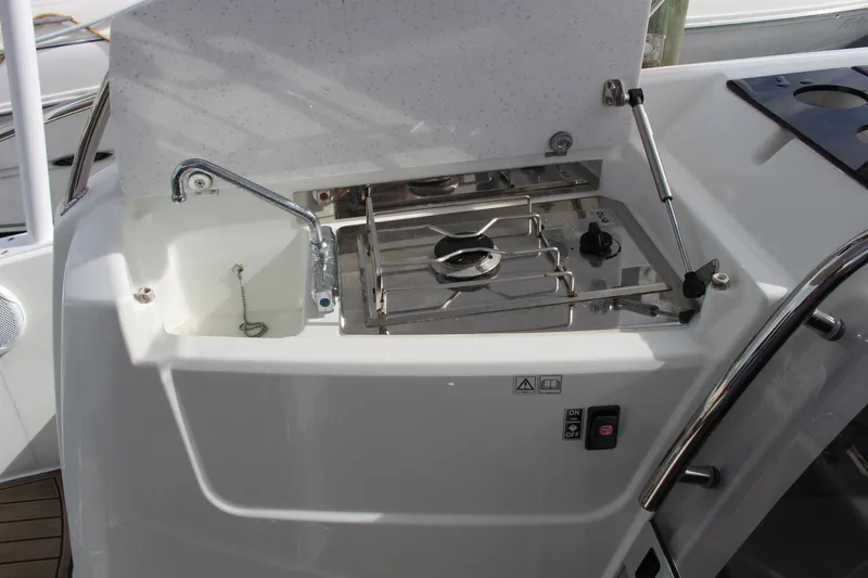  Yacht Photos Pics Outdoor kitchenette on 2021 Jeanneau Leader 9.0 WA boat with sink and stove.