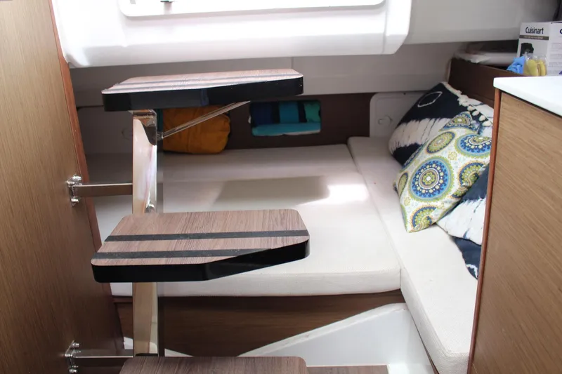  Yacht Photos Pics 2021 Jeanneau Leader 9.0 WA cabin interior with wooden steps and cozy seating area.