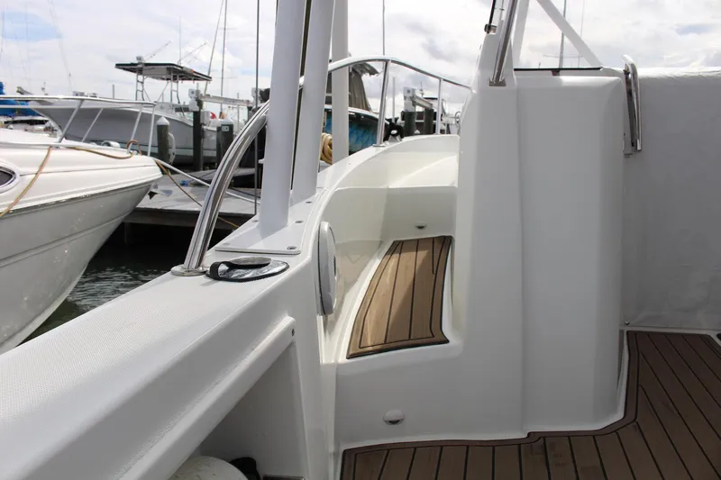  Yacht Photos Pics 2021 Jeanneau Leader 9.0 WA boat docked, featuring sleek design and wooden deck details.