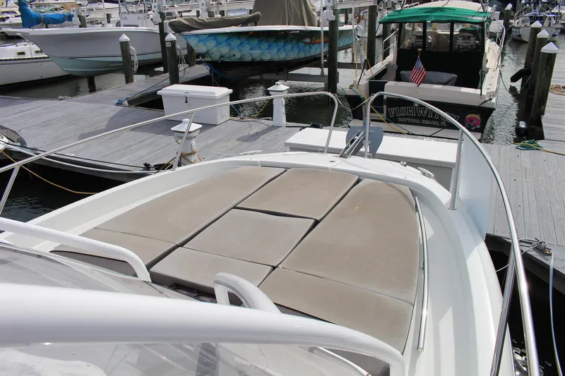  Yacht Photos Pics 2021 Jeanneau Leader 9.0 WA boat docked at marina with sunbathing area.