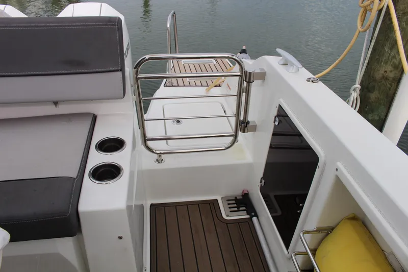  Yacht Photos Pics 2021 Jeanneau Leader 9.0 WA boat interior with seating and stainless steel railing.