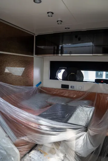 My Life Five III Yacht Photos Pics 2023 Rizzardi GR 63 yacht interior under construction, featuring covered furniture and modern cabinetry.