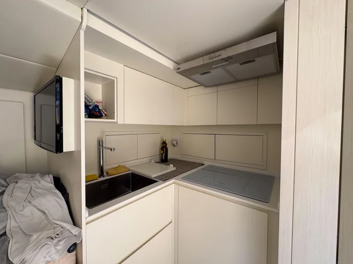 My Life Five III Yacht Photos Pics Compact modern kitchen in 2023 Rizzardi GR 63 yacht, featuring sleek cabinetry and appliances.