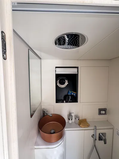 My Life Five III Yacht Photos Pics Modern bathroom interior of 2023 Rizzardi GR 63 yacht with copper sink and sleek design.