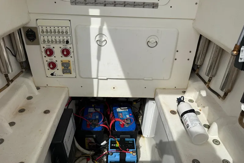  Yacht Photos Pics 2011 Contender 32 ST boat electrical panel and battery compartment with fire extinguisher.