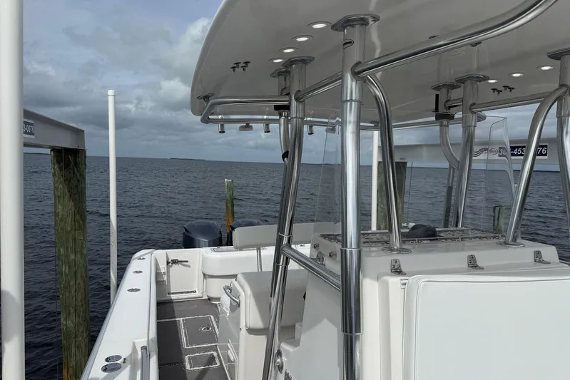  Yacht Photos Pics 2011 Contender 32 ST boat docked by the ocean under cloudy skies.