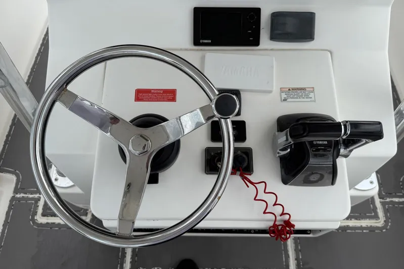  Yacht Photos Pics Steering console of a 2011 Contender 32 ST boat with Yamaha controls.
