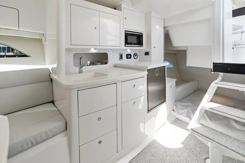  Yacht Photos Pics 2024 Intrepid 41 Valor interior with kitchenette, seating, and modern amenities.