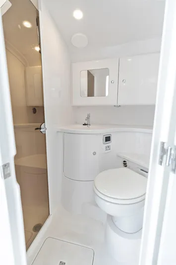  Yacht Photos Pics 2024 Intrepid 41 Valor yacht bathroom with modern fixtures and sleek white design.