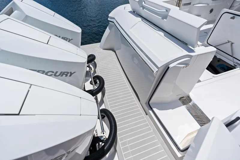  Yacht Photos Pics 2024 Intrepid 41 Valor boat with powerful Mercury outboard engines, docked on calm water.