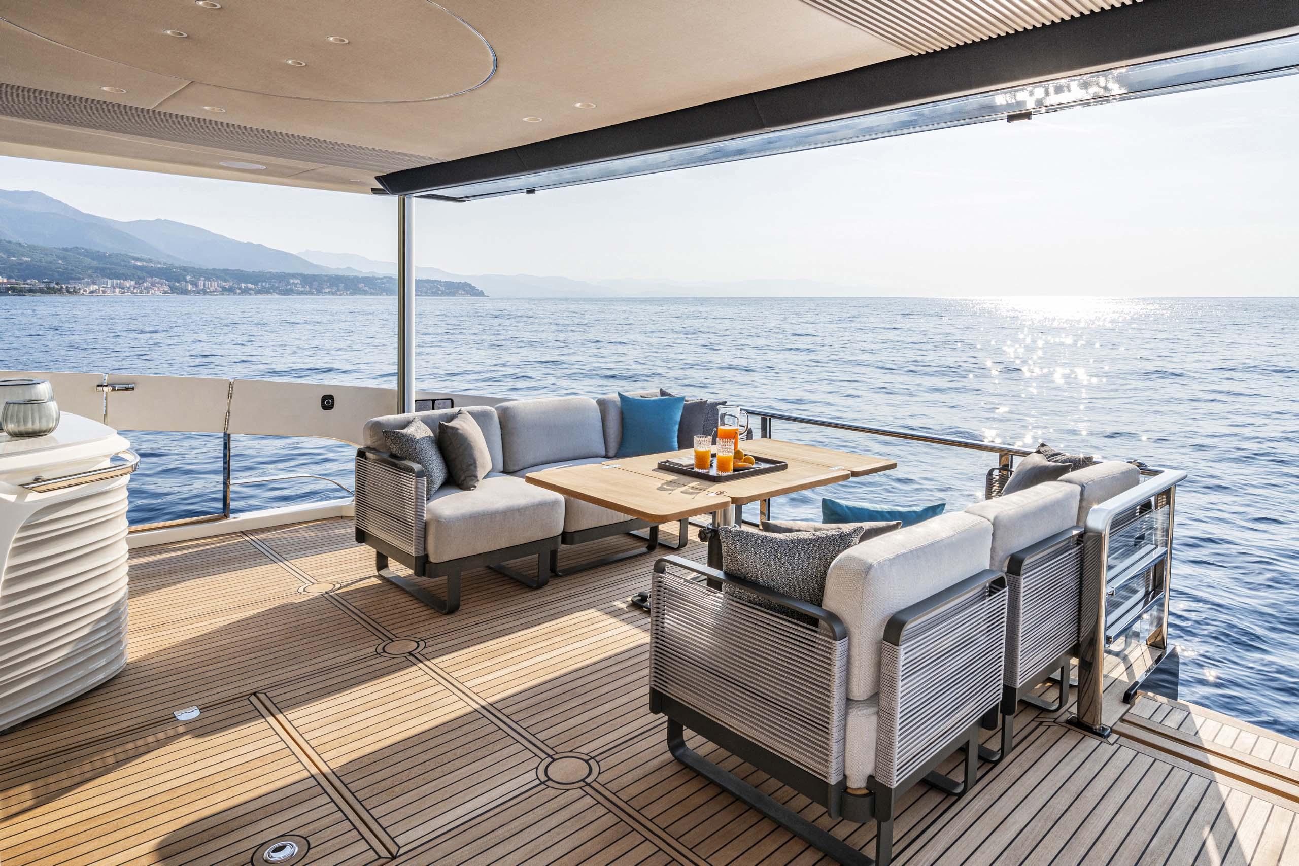 Luxurious deck of 2026 Absolute 70' Navetta yacht with ocean view.