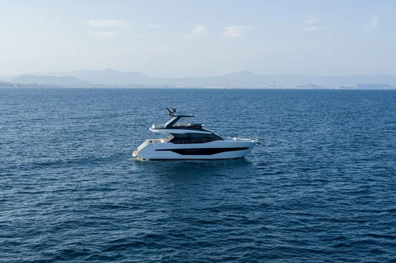 As 5 Yacht Photos Pics 2026 Astondoa AS 5 yacht cruising on open sea with distant mountains.