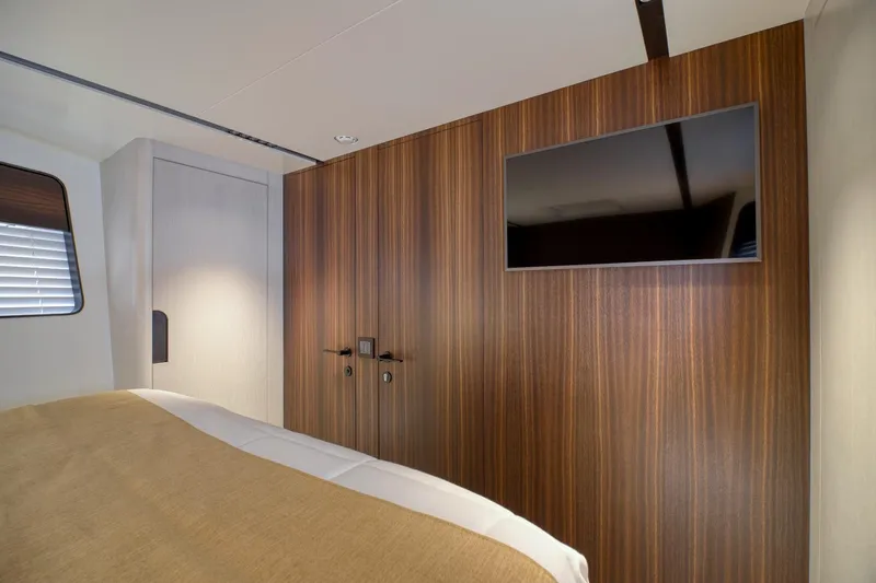 As 5 Yacht Photos Pics Luxurious cabin interior of 2026 Astondoa AS 5 yacht with wood paneling and TV.