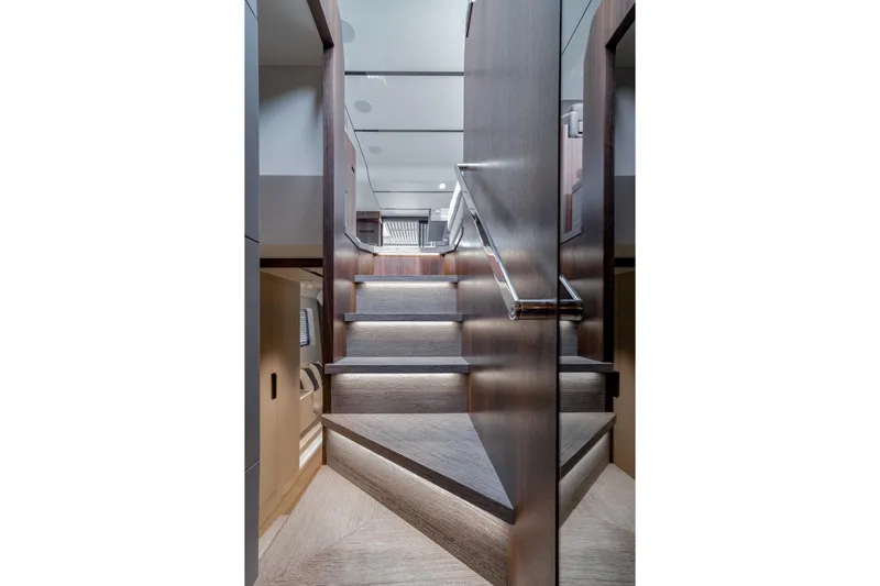 As 5 Yacht Photos Pics Staircase inside 2026 Astondoa AS 5 yacht, featuring modern wood and metal design.