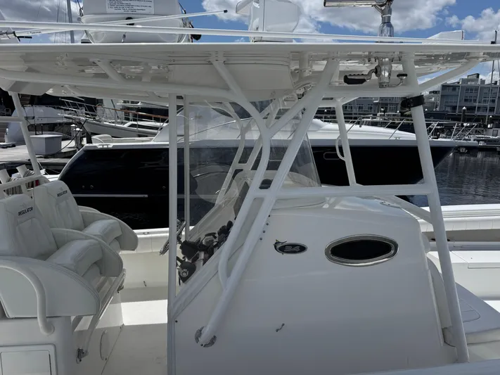  Yacht Photos Pics 2014 Regulator 34 Center Console boat with white seating and helm, docked at a marina.