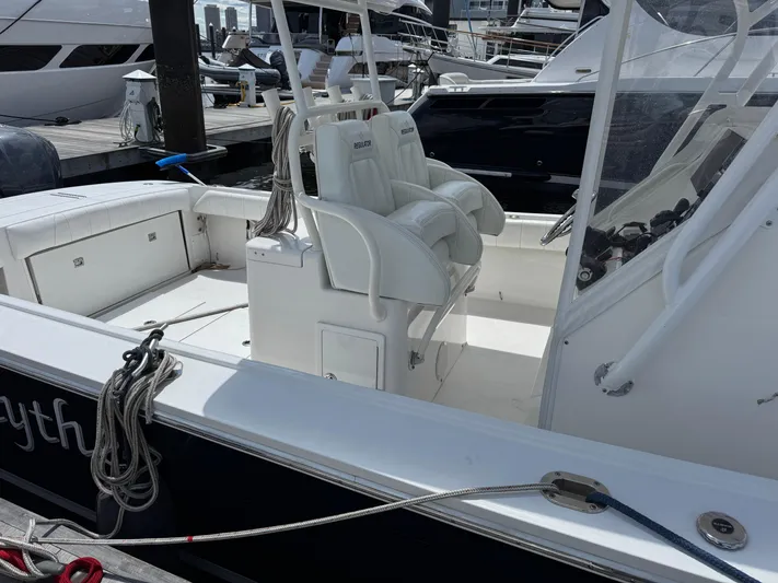 Yacht Photos Pics 2014 Regulator 34 Center Console boat docked, featuring white seating and clean deck.