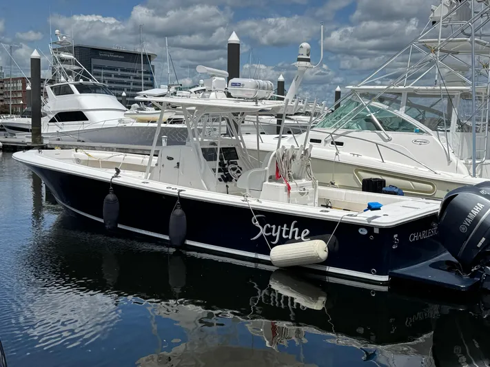  Yacht Photos Pics 2014 Regulator 34 Center Console boat docked in marina, clear sky, calm water.