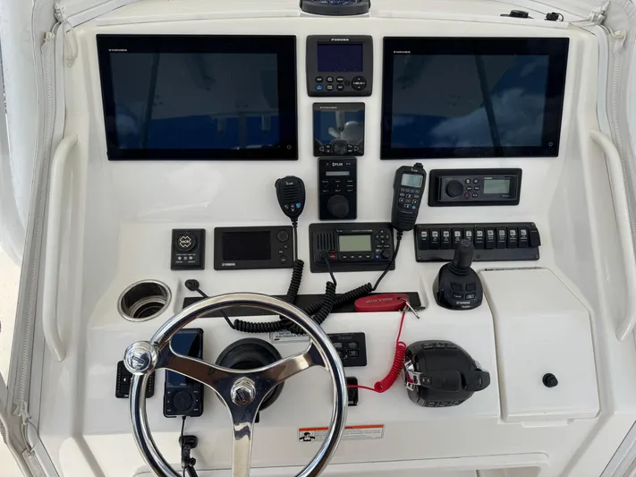  Yacht Photos Pics 2014 Regulator 34 Center Console helm with dual screens and navigation controls.