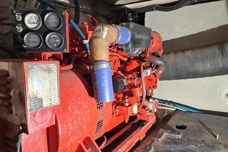 Nobody Yacht Photos Pics Engine compartment of a 1988 Ocean Yachts 48 Super Sport, featuring a red generator.