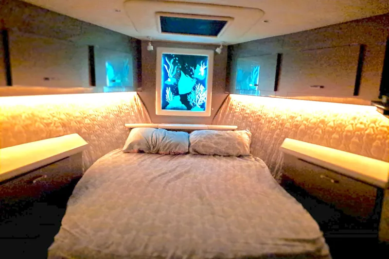 Nobody Yacht Photos Pics Luxurious bedroom interior of 1988 Ocean Yachts 48 Super Sport with ambient lighting.
