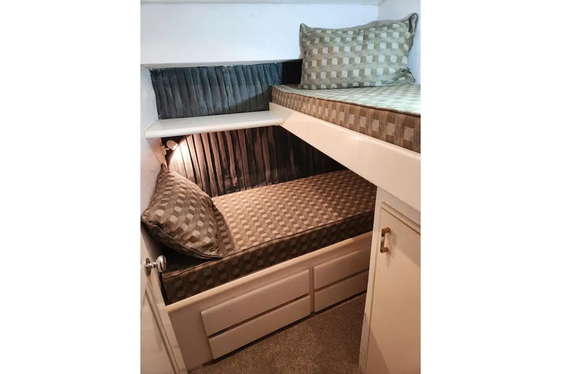 Nobody Yacht Photos Pics 1988 Ocean Yachts 48 Super Sport cabin with cozy twin bunks and checkered bedding.