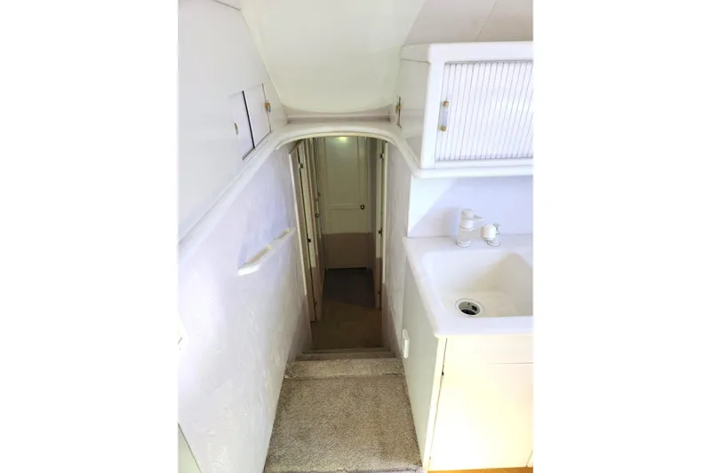 Nobody Yacht Photos Pics Interior view of 1988 Ocean Yachts 48 Super Sport, featuring stairs and a compact sink area.