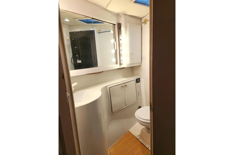 Nobody Yacht Photos Pics Bathroom interior of 1988 Ocean Yachts 48 Super Sport, featuring modern fixtures and lighting.
