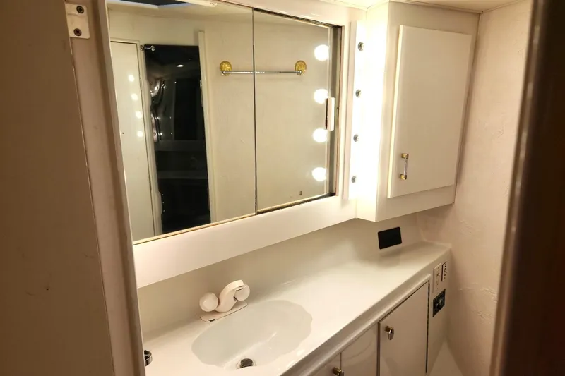 Nobody Yacht Photos Pics Bathroom vanity in 1988 Ocean Yachts 48 Super Sport, featuring mirror and lighting.