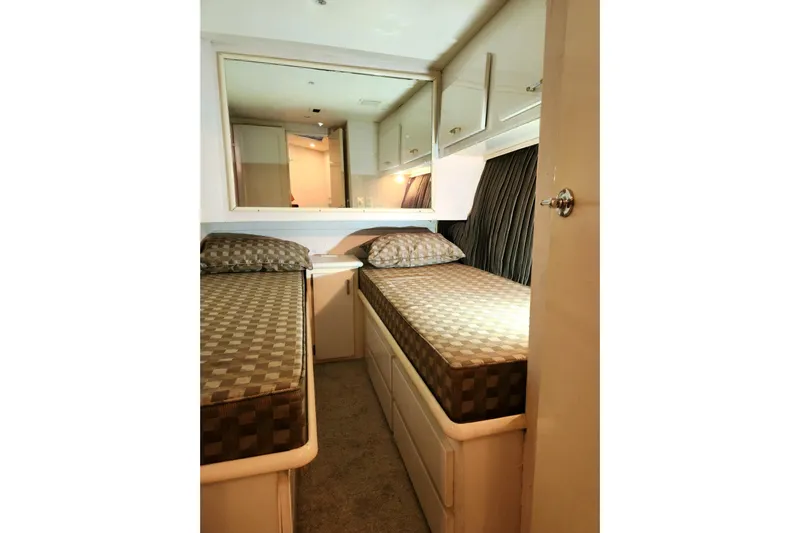 Nobody Yacht Photos Pics 1988 Ocean Yachts 48 Super Sport cabin with twin beds and storage cabinets.