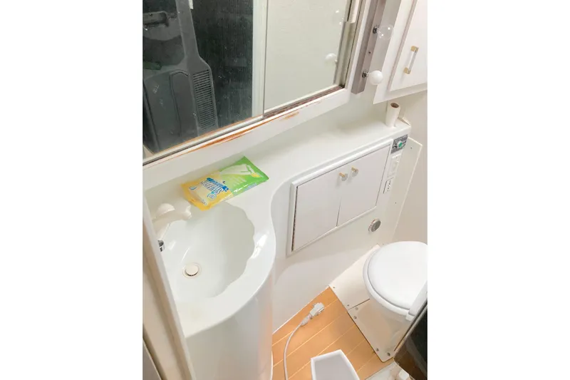 Nobody Yacht Photos Pics Bathroom interior of 1988 Ocean Yachts 48 Super Sport, featuring sink and toilet.