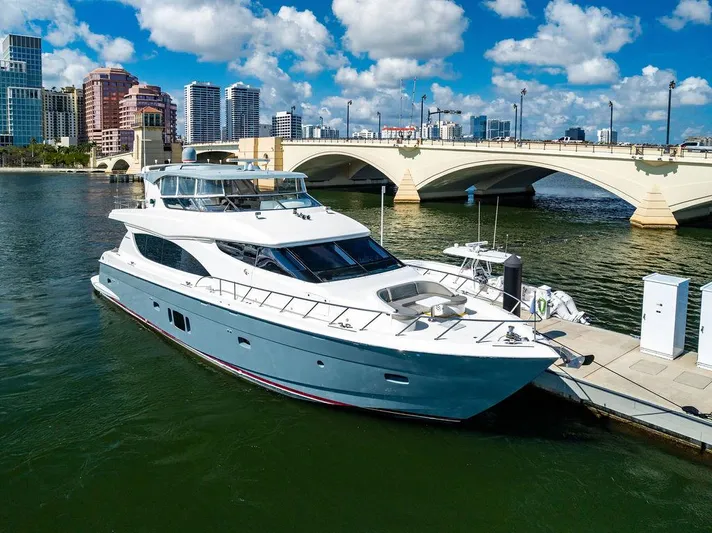 Yacht Photos Pics 2013 Hatteras 80 Motor Yacht docked near a bridge, city skyline in background.