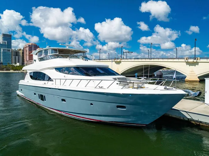  Yacht Photos Pics 2013 Hatteras 80 Motor Yacht docked near a bridge under a blue sky.