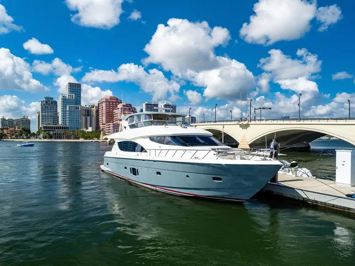  Yacht Photos Pics 2013 Hatteras 80 Motor Yacht docked near city skyline and bridge.