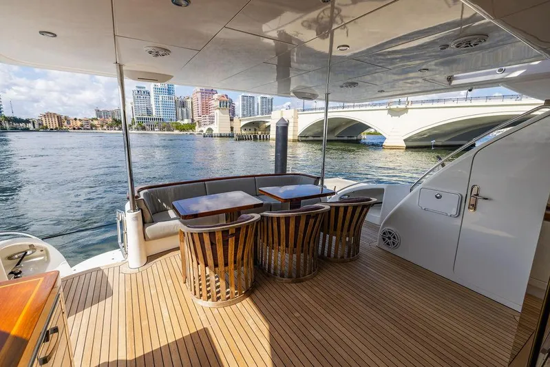  Yacht Photos Pics 2013 Hatteras 80 Motor Yacht deck with elegant seating and waterfront view.