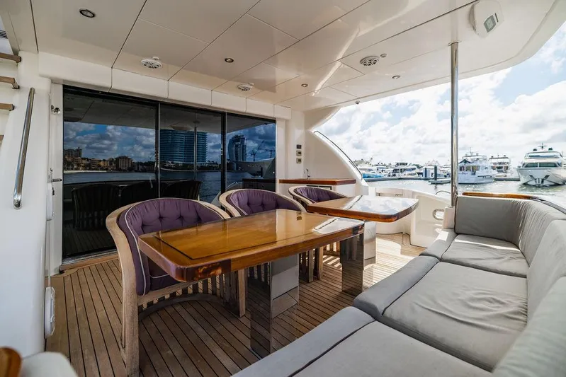  Yacht Photos Pics Luxurious 2013 Hatteras 80 Motor Yacht deck with elegant seating and marina view.
