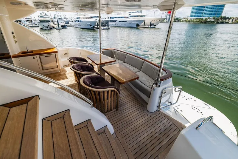  Yacht Photos Pics Luxurious 2013 Hatteras 80 Motor Yacht deck with elegant seating and waterfront view.