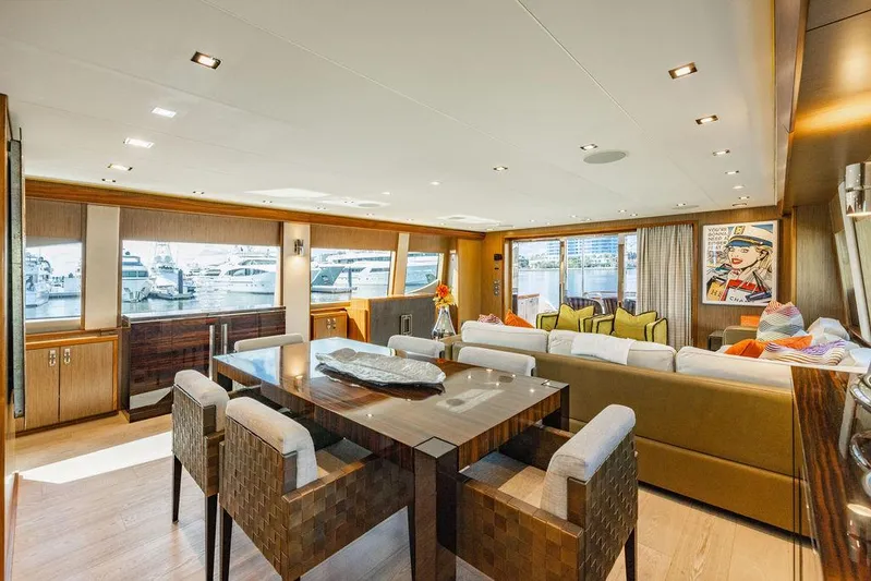  Yacht Photos Pics Luxurious interior of 2013 Hatteras 80 Motor Yacht with elegant dining and seating area.