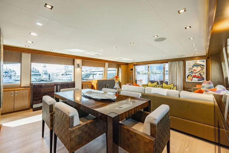  Yacht Photos Pics Luxurious interior of 2013 Hatteras 80 Motor Yacht with modern dining and seating area.