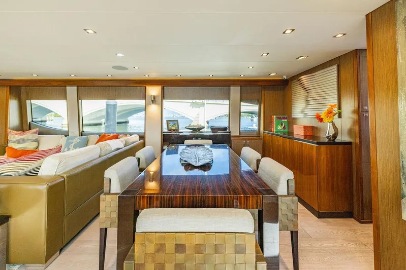  Yacht Photos Pics Luxurious interior of 2013 Hatteras 80 Motor Yacht with elegant dining area and plush seating.