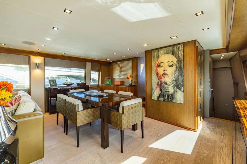  Yacht Photos Pics Luxurious interior of 2013 Hatteras 80 Motor Yacht with modern dining area and artwork.