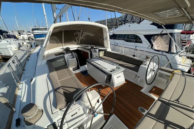 La Bella Vita Yacht Photos Pics 2015 Beneteau Oceanis 45 sailboat with spacious cockpit and dual steering wheels in marina.