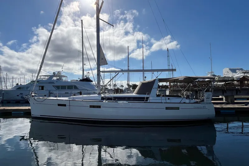 La Bella Vita Yacht Photos Pics 2015 Beneteau Oceanis 45 sailboat docked at marina under blue sky.